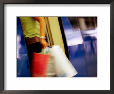 Person With Shopping Bags Entering A Carriage Of The Skytrain, Bangkok, Thailand by Ray Laskowitz Pricing Limited Edition Print image