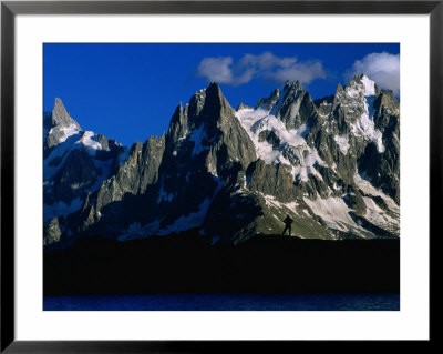 Walker Silhouetted Against Chamonix Needles On Route Of Tour Du Mont Blanc, Mont Blanc, France by Gareth Mccormack Pricing Limited Edition Print image
