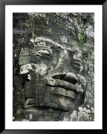 A Serene Likeness Of Buddha Sculpted Of Stone Peers From A Temple Wall by Paul Chesley Pricing Limited Edition Print image