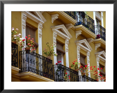 Spain, Sevilla, Andalucia Geraniums Hang Over Iron Balconies Of Traditional Houses by John & Lisa Merrill Pricing Limited Edition Print image