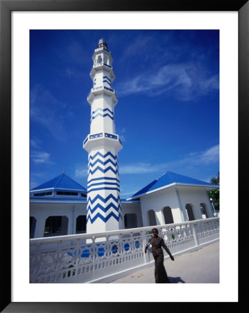 Woman Walking Past Minaret Eydhafushi, South Maalhosmadulu Atoll, Baa, Maldives by John Borthwick Pricing Limited Edition Print image