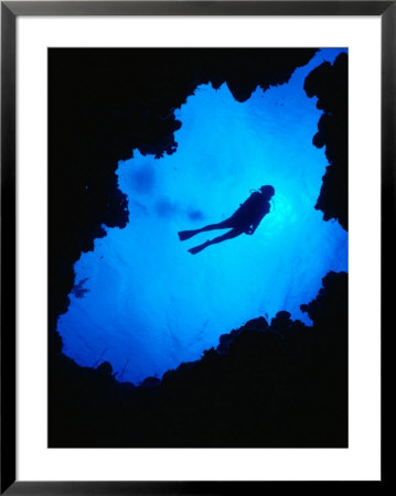 Diving Off Limestone Platform Into Blue Hole At Bat Cave, Gene's Bay, Bahamas by Michael Lawrence Pricing Limited Edition Print image