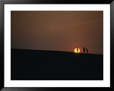 Surfers At Sunset On The Outer Banks by Emory Kristof Pricing Limited Edition Print image