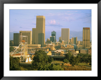 An Abandoned Mining Headframe Sits In Front Of Skyscrapers Downtown by Michael S. Lewis Pricing Limited Edition Print image