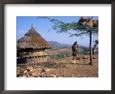 Mother And Child Walk Through A Konso Village, Omo River Region, Ethiopia by Janis Miglavs Pricing Limited Edition Print image