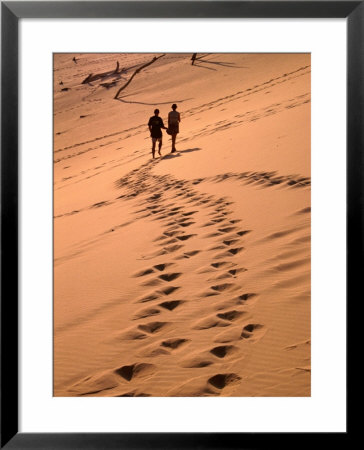 Couple Walking On Dunes, Great Sandy National Park, Australia by Wayne Walton Pricing Limited Edition Print image
