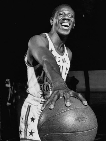 Harlem Globetrotter Reece Goose Tatum Holding A Basketball With One Hand by J. R. Eyerman Pricing Limited Edition Print image