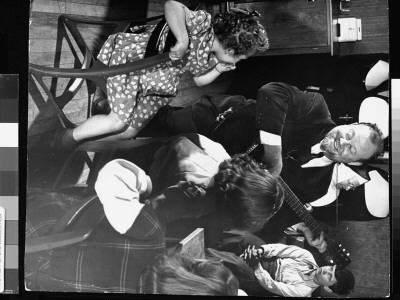 Balladeer Burl Ives Playing Guitar, Amidst A Group Of Children At St. Joseph's Home For Friendless by Wallace Kirkland Pricing Limited Edition Print image