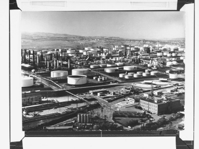 Dozens Of Large Storage Tanks In The Expansive Industrial Complex Of A Union Oil Company Refinery by J. R. Eyerman Pricing Limited Edition Print image