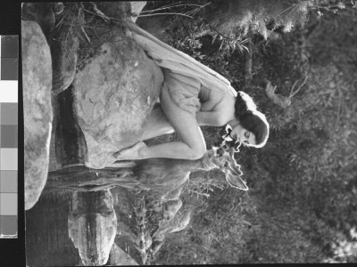 Pier Angeli In Strapless Chiffon Party Dress On A Rock In A Pond As She Whispers In The Woods by Allan Grant Pricing Limited Edition Print image