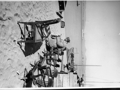 Chinese Nationalist Soldier In Office Chair As He Guards Several Other Wooden Swivel Chairs by Carl Mydans Pricing Limited Edition Print image