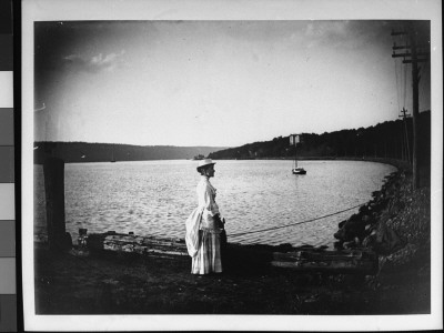 Mamie Montgomery Wearing A White Dress And Hat And Posing On A Dock Near The Hudson River by Wallace G. Levison Pricing Limited Edition Print image