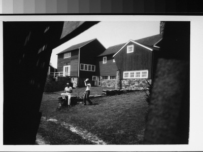 Dancer Jose Limon Seated On Wall Outside His Home; Unidentified Man Approaching by Gjon Mili Pricing Limited Edition Print image