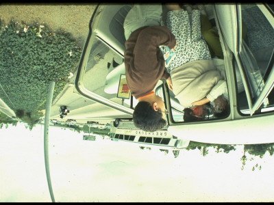 Bloodied Car Acccident Victim Assisting Other Sitting In Car On Roadside by Ralph Crane Pricing Limited Edition Print image