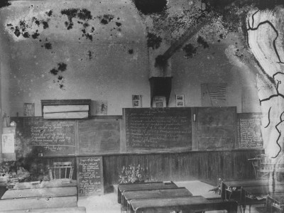 Interior Of A School Room With Writing On The Blackboards by Wallace G. Levison Pricing Limited Edition Print image