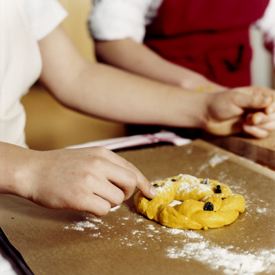Two Girls Making A Saffron Bun For Christmas, Sweden by Niclas Albinsson Pricing Limited Edition Print image