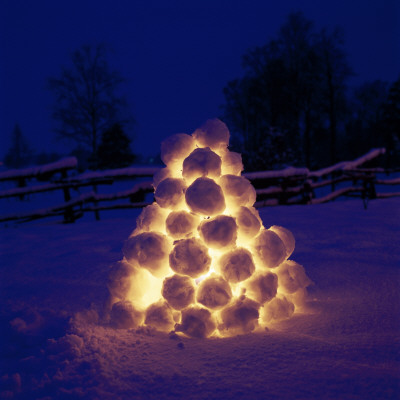 Pyramid Made Of Snowballs Lit Up At Night by Ove Eriksson Pricing Limited Edition Print image