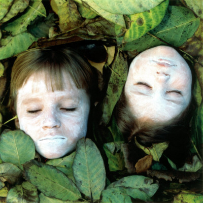 White Faces Of Two Little Girls Resting In A Bed Of Leaves by Mikael Bertmar Pricing Limited Edition Print image