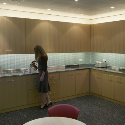 Office Life And Interiors Part Two, Woman Making Tea In Kitchen by Tim Mitchell Pricing Limited Edition Print image