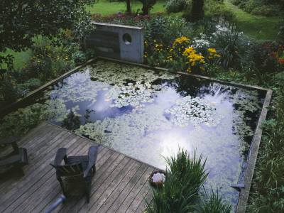 Concrete Sculpture, Lily Pond, Decking And Adirondack Chairs by Clive Nichols Pricing Limited Edition Print image