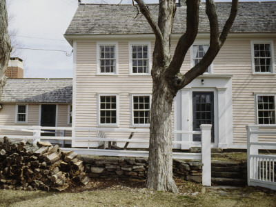 Timber Frame Clapboard Farmhouse In Winter, Logpile Of Firewood, Lyme, Connecticut by Philippa Lewis Pricing Limited Edition Print image
