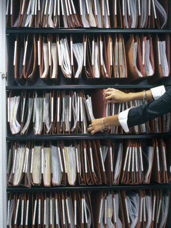 Office Life And Interiors, Filing Cupboard And Hands Of Woman Filing by Nicholas Kane Pricing Limited Edition Print image