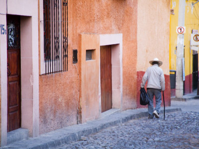 Man Walking Down Street, San Miguel De Allende, Mexico by Julie Eggers Pricing Limited Edition Print image