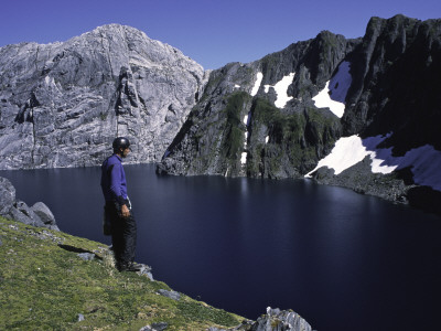 A Climber Enjoying The View Over A Mountain Lake, Chile by Pablo Sandor Pricing Limited Edition Print image