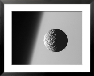 This Amazing Perspective View Captures Battered Moon Mimas Against The Hazy Limb Of Planet Saturn by Stocktrek Images Pricing Limited Edition Print image