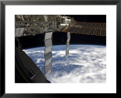 International Space Station Backdropped Againts A Blue And White Earth by Stocktrek Images Pricing Limited Edition Print image
