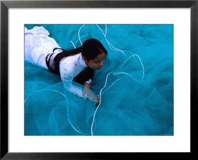 School Girl Lies On Fishing Net On Vietnam's Coast, Da Nang, Vietnam by Stu Smucker Pricing Limited Edition Print image