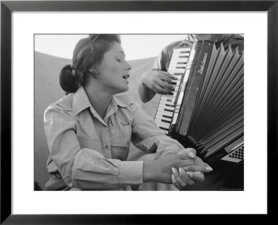 Young Israeli Woman Singing While Accompanied By Someone Playing An Accordion by Paul Schutzer Pricing Limited Edition Print image