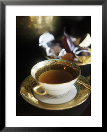 A Cup Of Tea With Chocolate Truffles In Background by Bernhard Winkelmann Pricing Limited Edition Print image