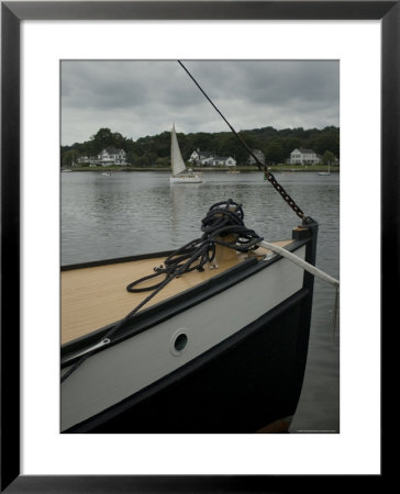 Bow Of A Boat With A Sailboat In The Background On The Mystic River, Connecticut by Todd Gipstein Pricing Limited Edition Print image