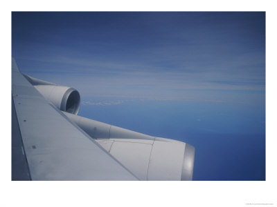 A Close View Of The Wing And Jet Engines Of A Plane In Flight by Raul Touzon Pricing Limited Edition Print image