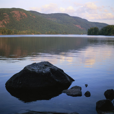 Rock Juts Forth From A Placid Lake by Stephen Alvarez Pricing Limited Edition Print image