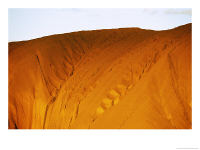The Setting Sun Casts A Golden Glow On An Uluru Rock Formation by Jason Edwards Pricing Limited Edition Print image