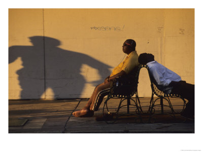 Two Men Relax On City Benches In Downtown New Orleans by Joel Sartore Pricing Limited Edition Print image