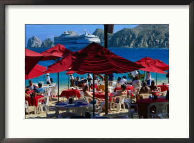 Tourists At Outdoor Cafe Under Umbrellas At Mendano Beach, Cabo San Lucas, Mexico by Mark & Audrey Gibson Pricing Limited Edition Print image