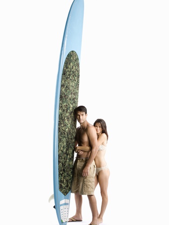 A Couple Standing With A Surfboard by Jonathan Gelber Pricing Limited Edition Print image