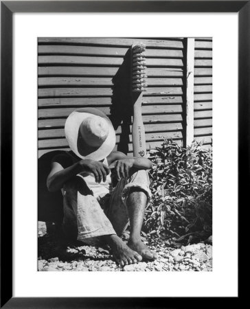 Haitian Native Engaged In A Siesta Next To Giant American Toothbrush Ad He Totes Around The Streets by Rex Hardy Jr. Pricing Limited Edition Print image