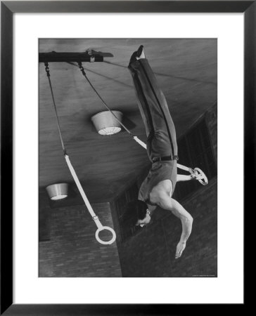 Intercollegiate Champion Gymnast Newt Loken On Flying Rings Doing Reverse Flyaway With Half Twist by Gjon Mili Pricing Limited Edition Print image