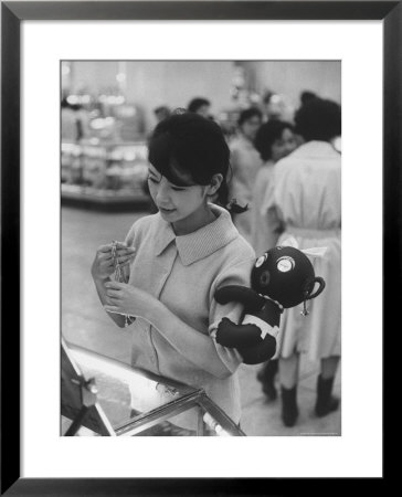 Japanese Girl With Dakkochan Doll On Her Arm by John Dominis Pricing Limited Edition Print image