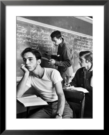 Beard Started On Teenage High School Student As Others Work On Lessons At Blackboard And Desk by Alfred Eisenstaedt Pricing Limited Edition Print image