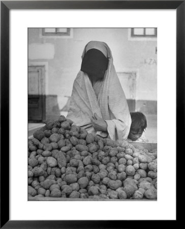 Moslem Woman Shopping For Potatoes by John Phillips Pricing Limited Edition Print image