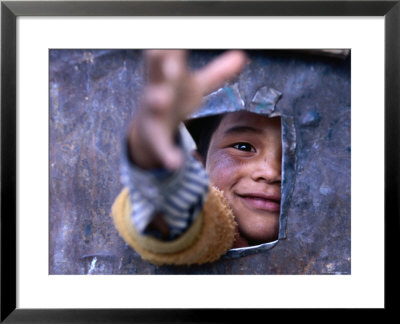 Boy Reaching Through Hole In Gate, Alchi, Jammu And Kashmir, India by Daniel Boag Pricing Limited Edition Print image