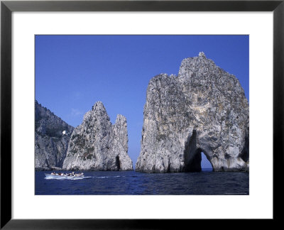 Faraglioni Rocks With A Boat In The Bay Of Naples At Capri Island In Italy by Richard Nowitz Pricing Limited Edition Print image