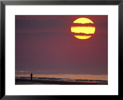 Person Silhouetted On The Beach At Sunrise by Kenneth Garrett Pricing Limited Edition Print image