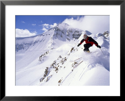 Downhill Skier Launching Off A Cornice In Front Of Lone Mountain by Gordon Wiltsie Pricing Limited Edition Print image
