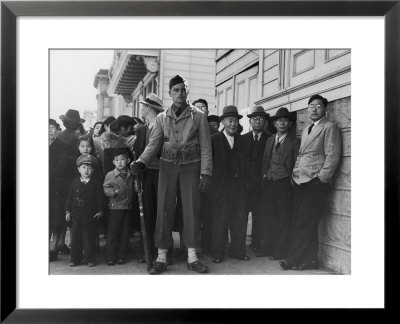 Soldier Standing Guard In Front Of Japanese American Citizens Awaiting Transport To Relocation Camp by Dorothea Lange Pricing Limited Edition Print image